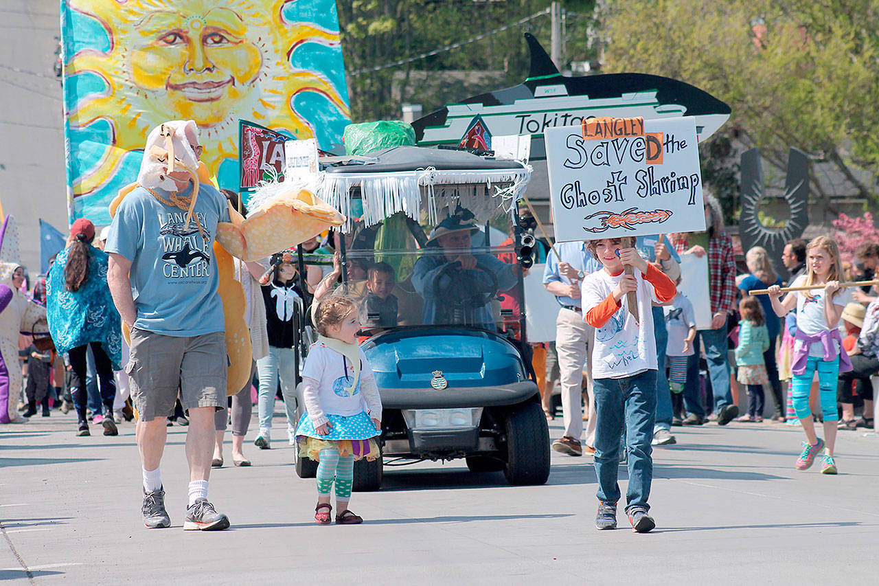 Record file — People walk up Second Street from Anthes Avenue for the annual Welcome the Whales Parade in Langley on April 18, 2015. The parade will return to Langley on April 8.