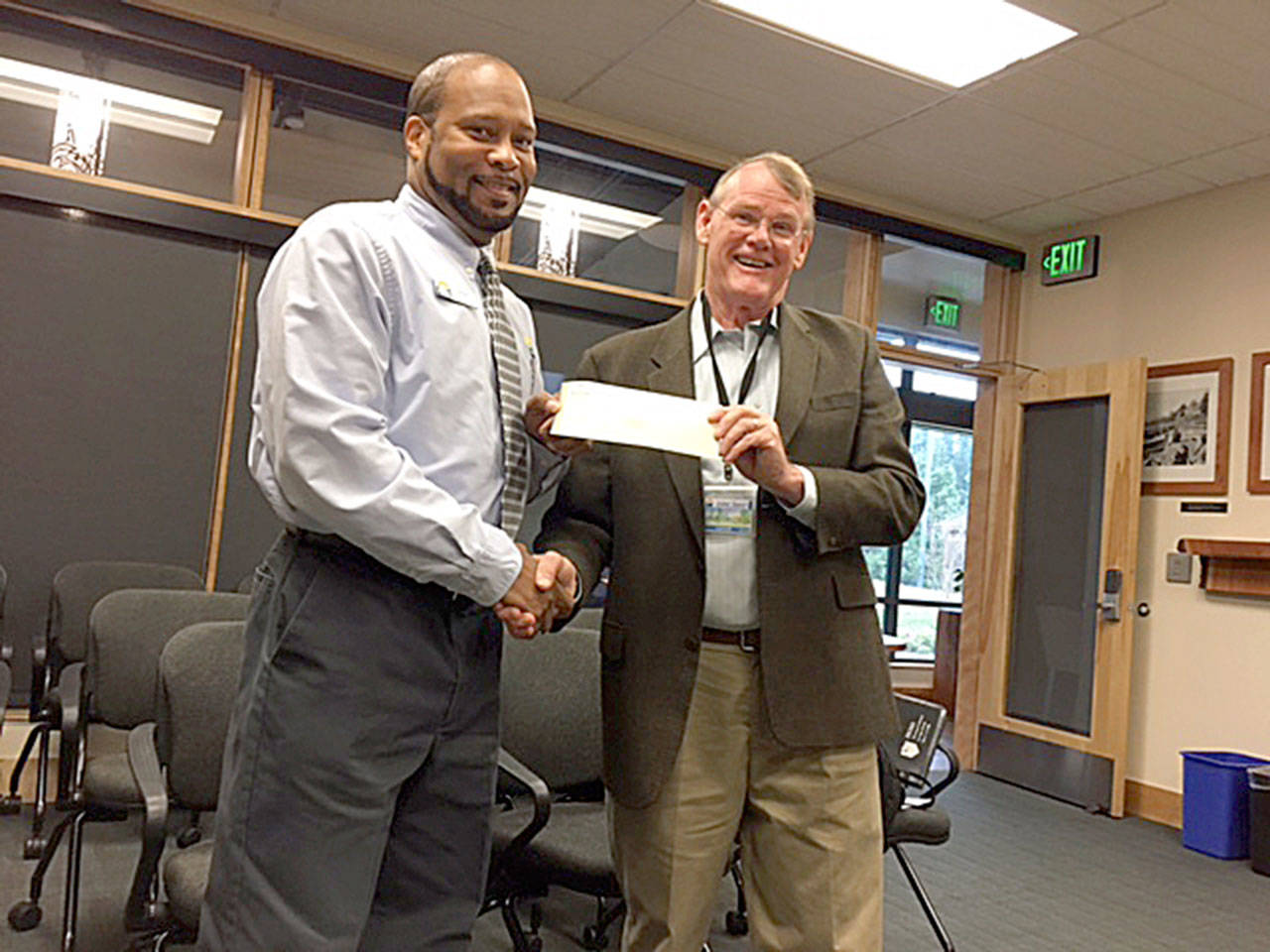 Photo provided                                Washington State Transit Insurance Pool Executive Director Al Hatten, right, presents an “Above & Beyond” award to Island Transit Operator Andre Smith.                                Contributed photo — Island Transit and the Washington State Transit Insurance Pool recently awarded bus operator Andre Smith for coming to the aid of a rider with a medical emergency.