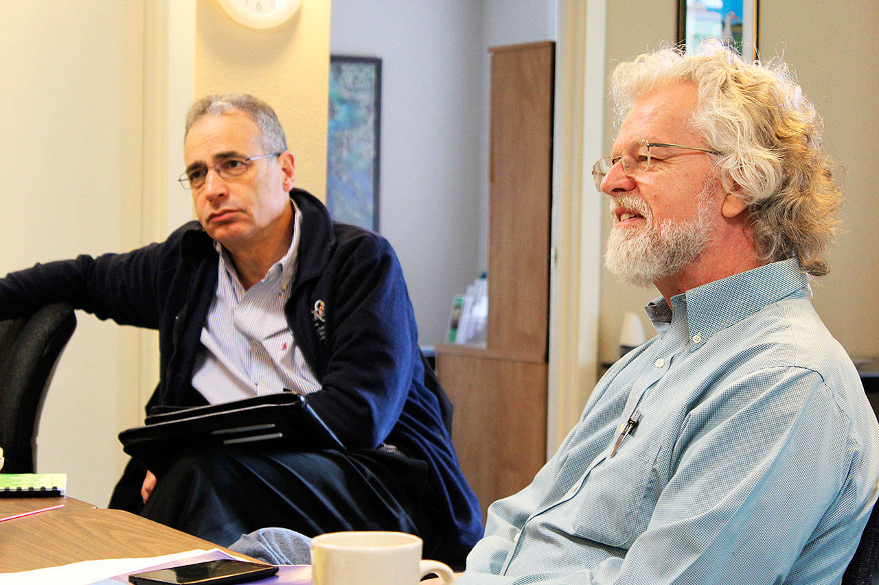 Photo by Patricia Guthrie/Whidbey News-Times                                Michael Shuman, left, author of a report on the “hidden costs” of Naval Air Station Whidbey Island, met at the Island County Economic Development Office in Coupeville Tuesday. Larry Morrell, right, is with the citizen group, Sustainable Economy Collaborative, which hired Shuman to write the report.