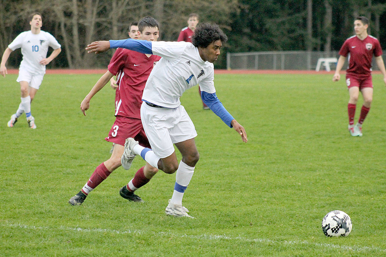 Evan Thompson / The Record — South Whidbey senior midfielder/defender Justin Gonzales chases after a contested ball during a match against Cedarcrest on Wednesday night at Waterman’s Field. The Falcons lost 3-0.