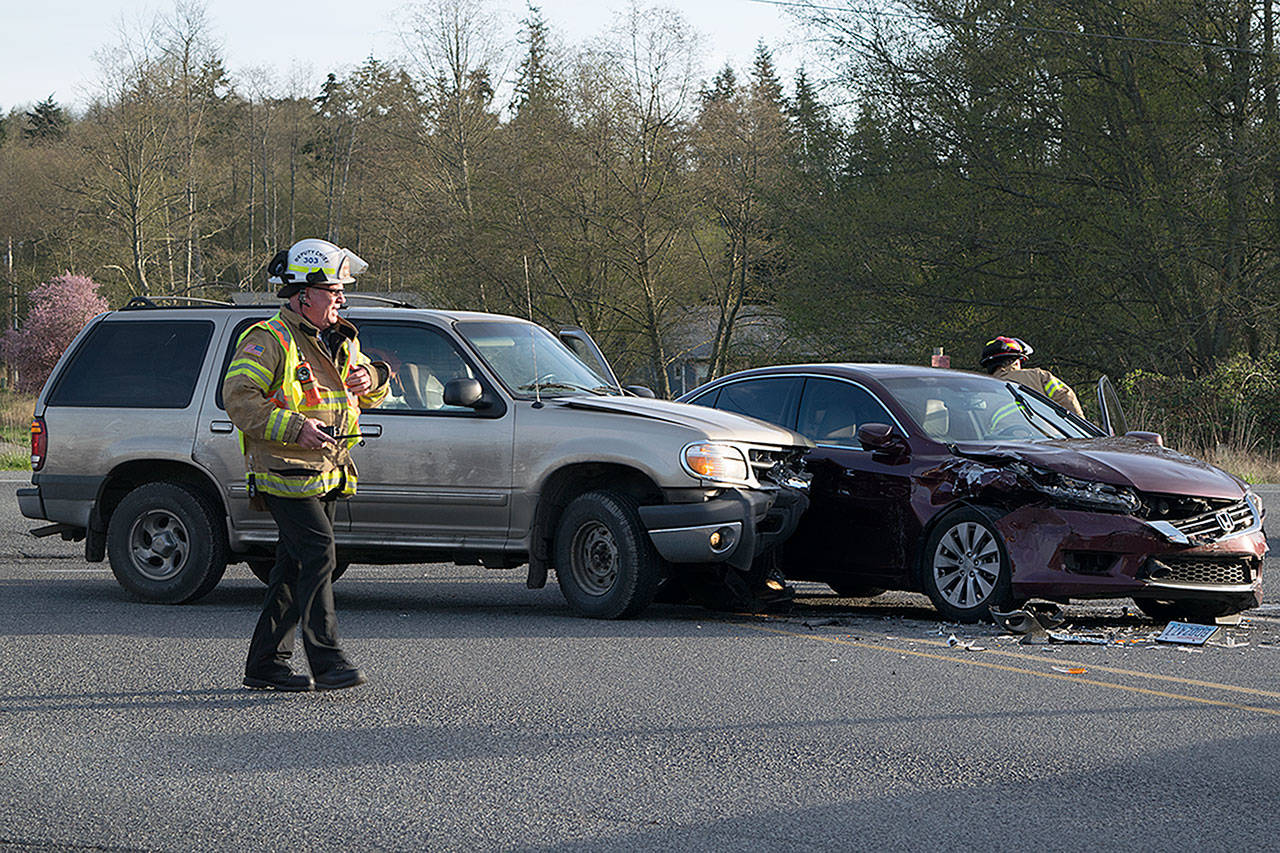 Kyle Jensen / The Record — South Whidbey Fire/EMS Deputy Chief Mike Cotton surveys the scene of a collision at the intersection of Highway 525 and Harbor Avenue in Freeland.