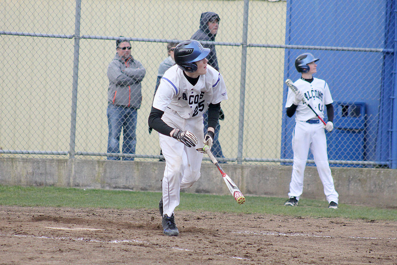 Evan Thompson / The Record — South Whidbey freshman Carson Wrightson looks up to watch his hit soar over the center field barrier for a home run on Monday afternoon against King’s. The Falcons won 10-0.