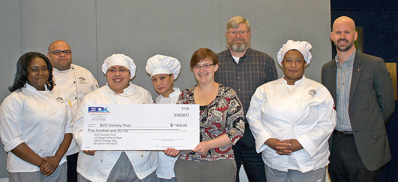 Contributed photo — From left to right in culinary uniforms, Michaela Jones, Chef Gil Rodriguez, Lizette Flores, Nicole Wynn and Maribel Nzokah. In plain clothes, Sami Postma, Island County Economic Development Council program coordinator, Ron Nelson, executive director of the economic development council, and Brad Tuininga, director of philanthropy for the Skagit Valley College Foundation.