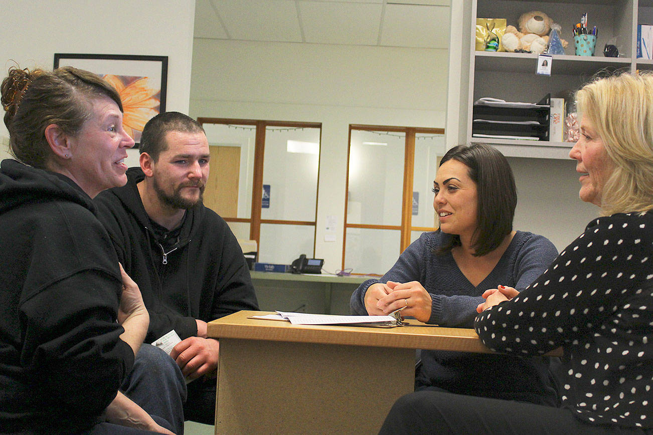 Carla Farnell and Shawn Lowe meet with Island County Housing Support Center staff Malissa Taylor and Joanne Pelant to discuss an assistance voucher. Living out of their car all winter, the homeless couple may soon be moving into an Oak Harbor apartment. Farnell lost her motel housekeeping job after five days of work when the employer discovered she was homeless and had given a fake address on her application. The windshield of their car was bashed in one day when they were away bathing in a creek. They then recived a traffic ticket for driving with a broken windshield. Photo by Patricia Guthrie/Whidbey News-Times