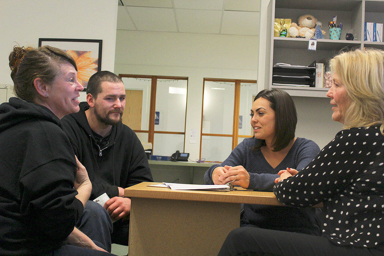 Carla Farnell and Shawn Lowe meet with Island County Housing Support Center staff Malissa Taylor (center) and Joanne Pelant (right) to discuss an assistance voucher to help them move into an apartment.Photo by Patricia Guthrie/Whidbey News-Times