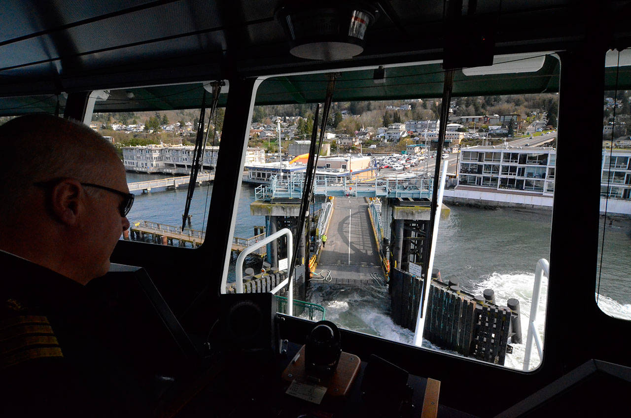 Justin Burnett/The Record — Washington State Ferries Captain Curt Larson approaches the Mukilteo Ferry Terminal in the Tokitae, route’s 144-car ferry. An analysis of performance statistics by The Record found the boat transported fewer total cars than its smaller counterparts in 2016, but still carried more cars per trip on average.