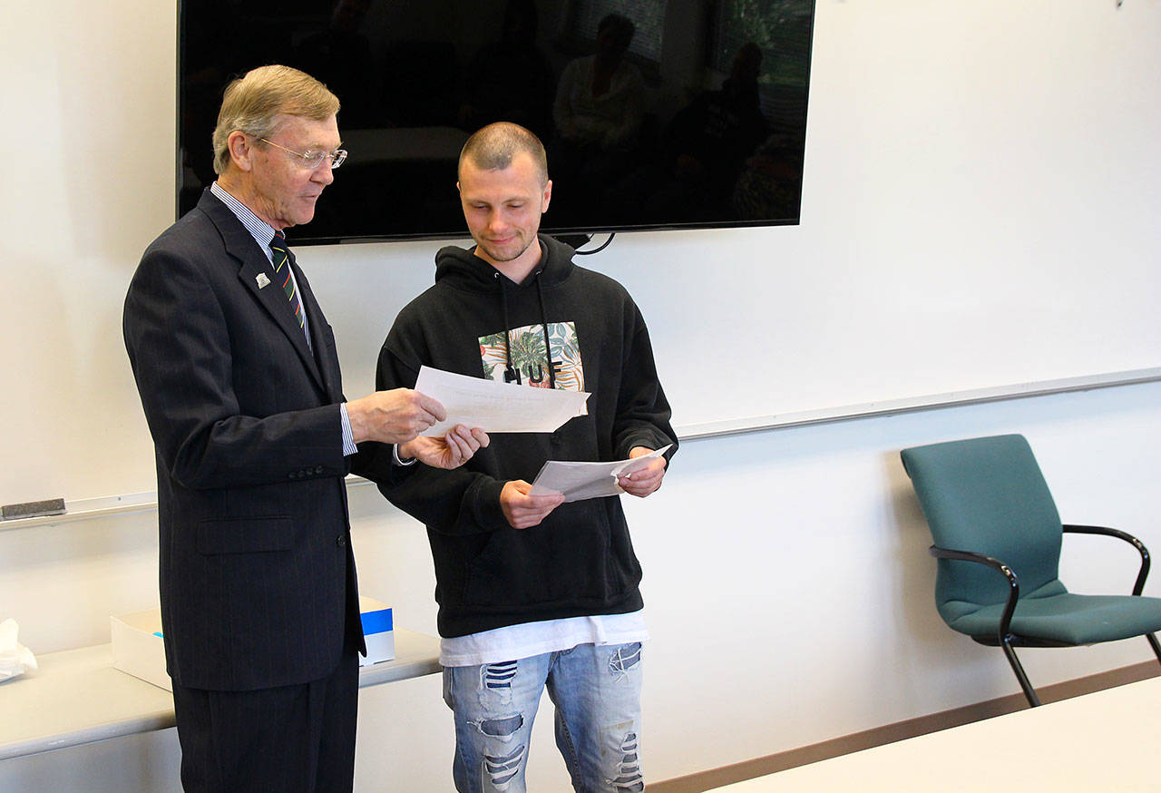 Jessie Stensland / Whidbey News-Times                                Island County Superior Court Judge Alan Hancock hands Kody Schwiger a certificate during hisgraduation from drug court last week.