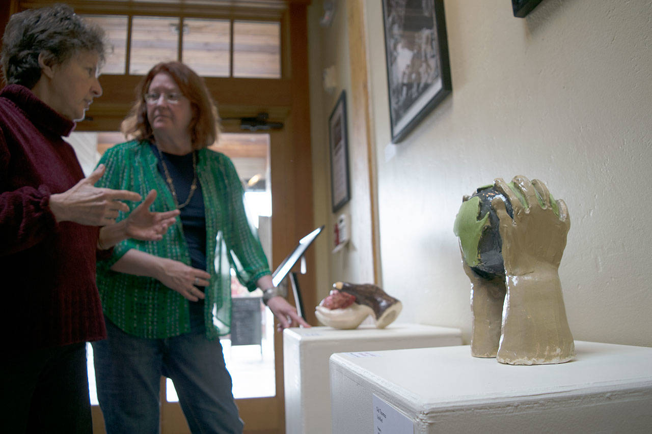 Kyle Jensen / The Record — Organizer Julie Glover (left) and Goosefoot Director of Programs Marian Myszkowski (right) discuss student sculptures.
