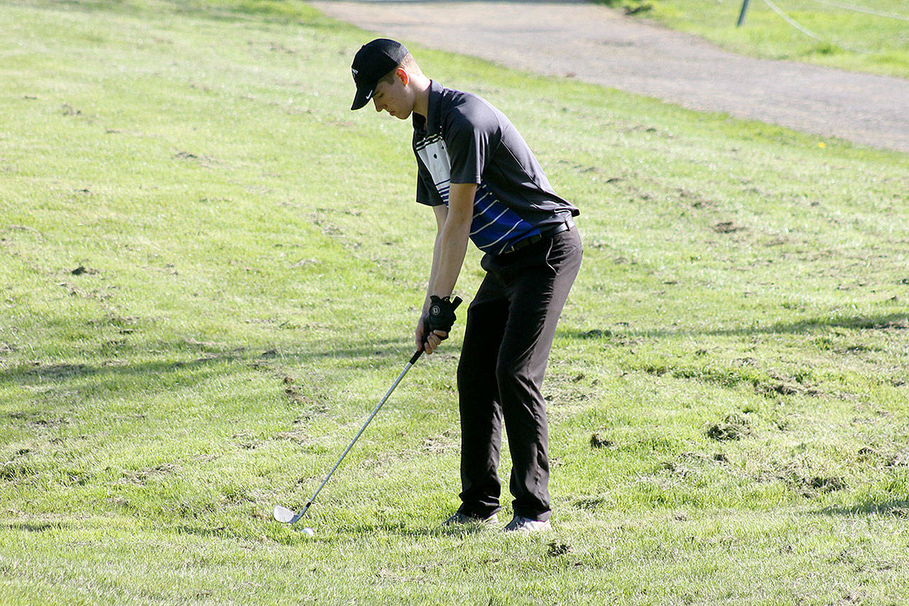 Evan Thompson / The Record — South Whidbey senior Anton Klein prepares for a shot in the rough on hole 9 during a match against King’s on Thursday afternoon at Useless Bay Golf and Country Club.