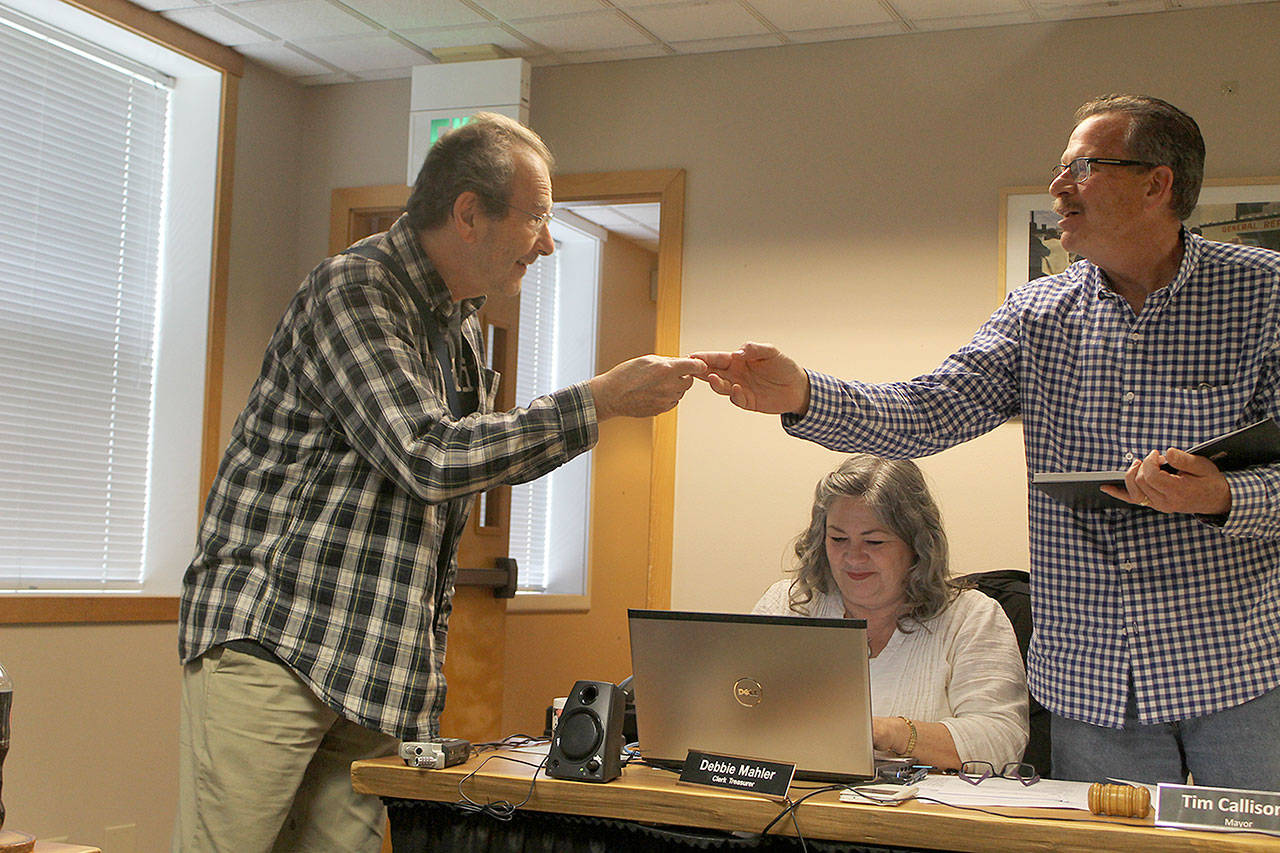 Evan Thompson / The Record &mdash; Drew Kampion, left, receives a Mayor&rsquo;s Excellence Award pin from Mayor Tim Callison at the Langley City Council&rsquo;s meeting on Monday night.
