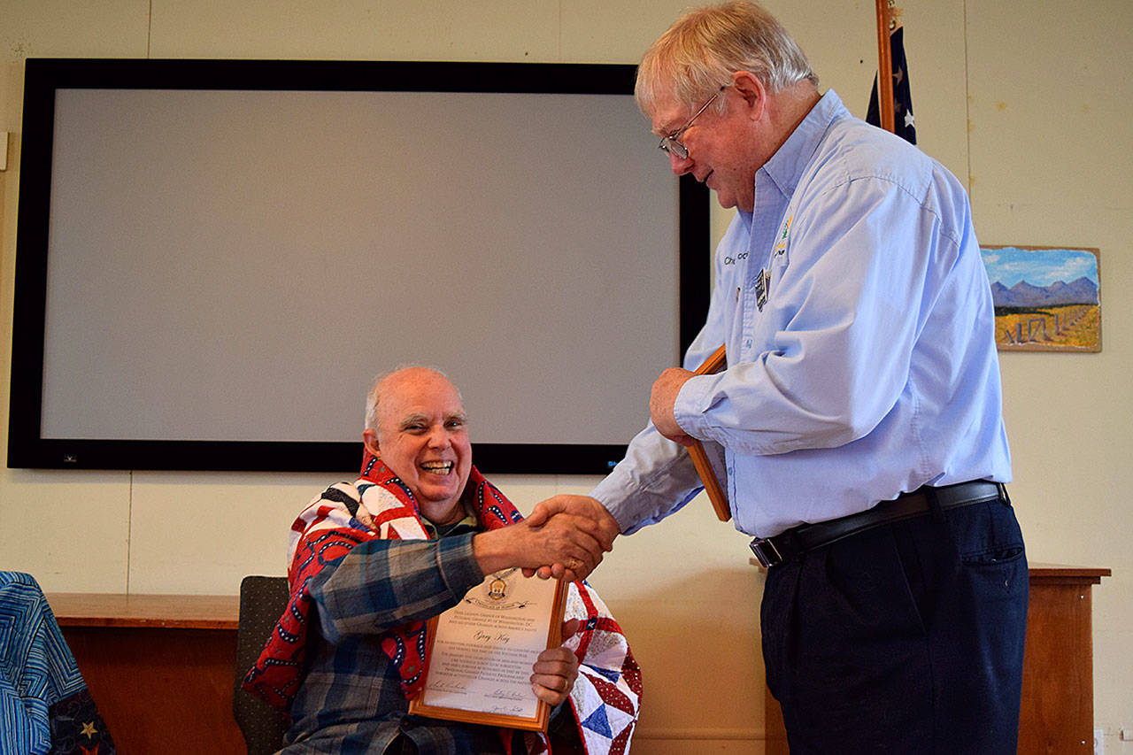 Kyle Jensen / The Record — Deer Lagoon Grange Master Chuck Prochaska presents an award to United States Navy veteran Gary Kay after Anita Smith presented him with a quilt made from her volunteer group.