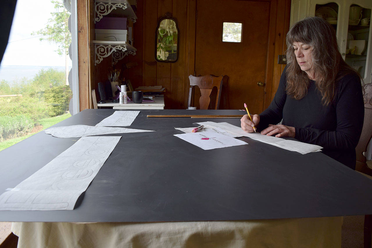 Kyle Jensen / The Record &mdash; Freeland resident Nora Harrell, also known as &ldquo;the sign lady,&rdquo; works on a sign for a new ice cream shop called Freeland Freeze.