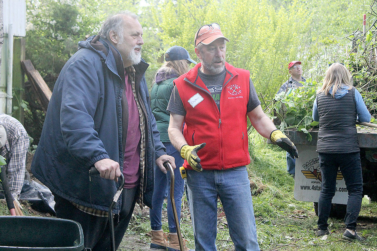 Evan Thompson / The Record &mdash; Rick Emlee, left, speaks with Hearts & Hammers work party team captain Clayton Granby during the non-profit organization&rsquo;s 24th annual workday on Saturday morning.