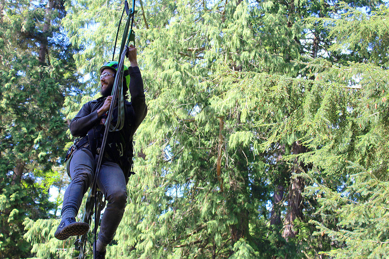 Guide Shaun Mellor demonstrates Canopy Tree Climbing in Deception State Park on May 14, 2017. Climbing to the top of a 200-foot Douglas fir with ropes and a harness is offered by the company, AdventureTerra. Two towering trees are used in the park; cost is $149 per person. Minimum age is 7 years old.
