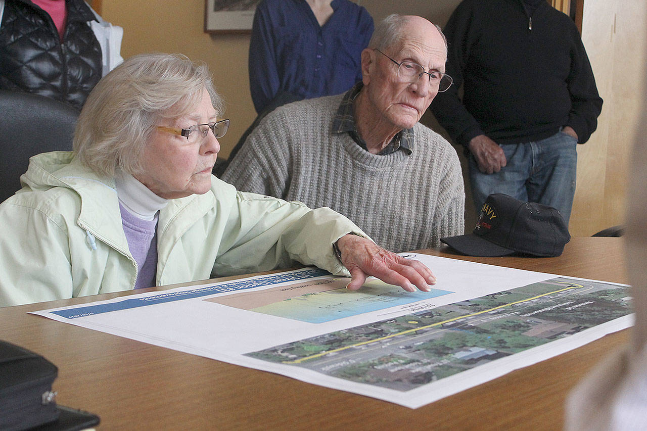 Evan Thompson / The Record — Jean and Milo Milfs examine an early schematic of the upcoming sidewalk project on First Street at a public meeting with residents and property owners on Tuesday at city hall.