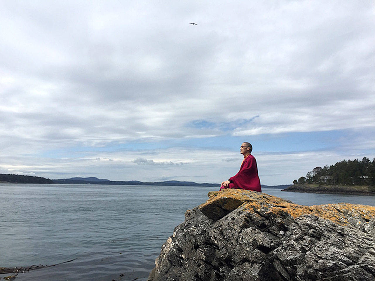 Kilung Foundation photo — Kilung Rinpoche, who lives and teaches on South Whidbey, meditates while overlooking Puget Sound. Rinpoche is a significant Tibetan Buddhist teacher and lineage holder.