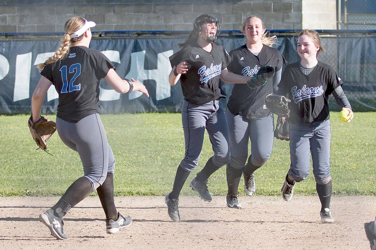 Paul Lien photo — South Whidbey freshman Makenna Morley is congratulated by her team after making the winning catch to send the Falcons to the class 1A softball championships.