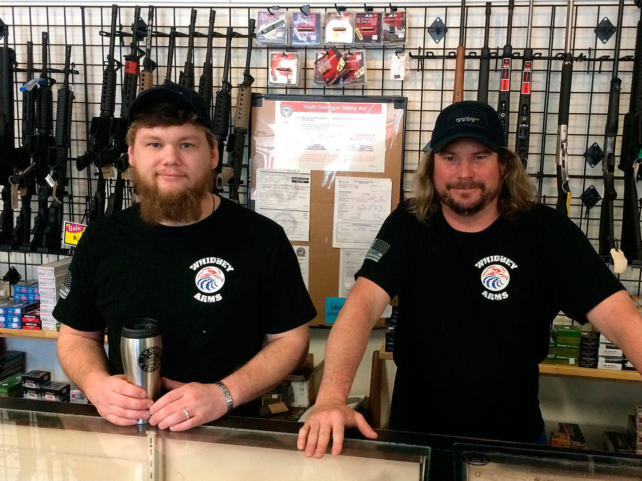 Contributed photo &mdash; New Whidbey Arms co-owners Craig Justus (left) and Mark Henny (right) saved the gun shop from closing when they purchased the business.
