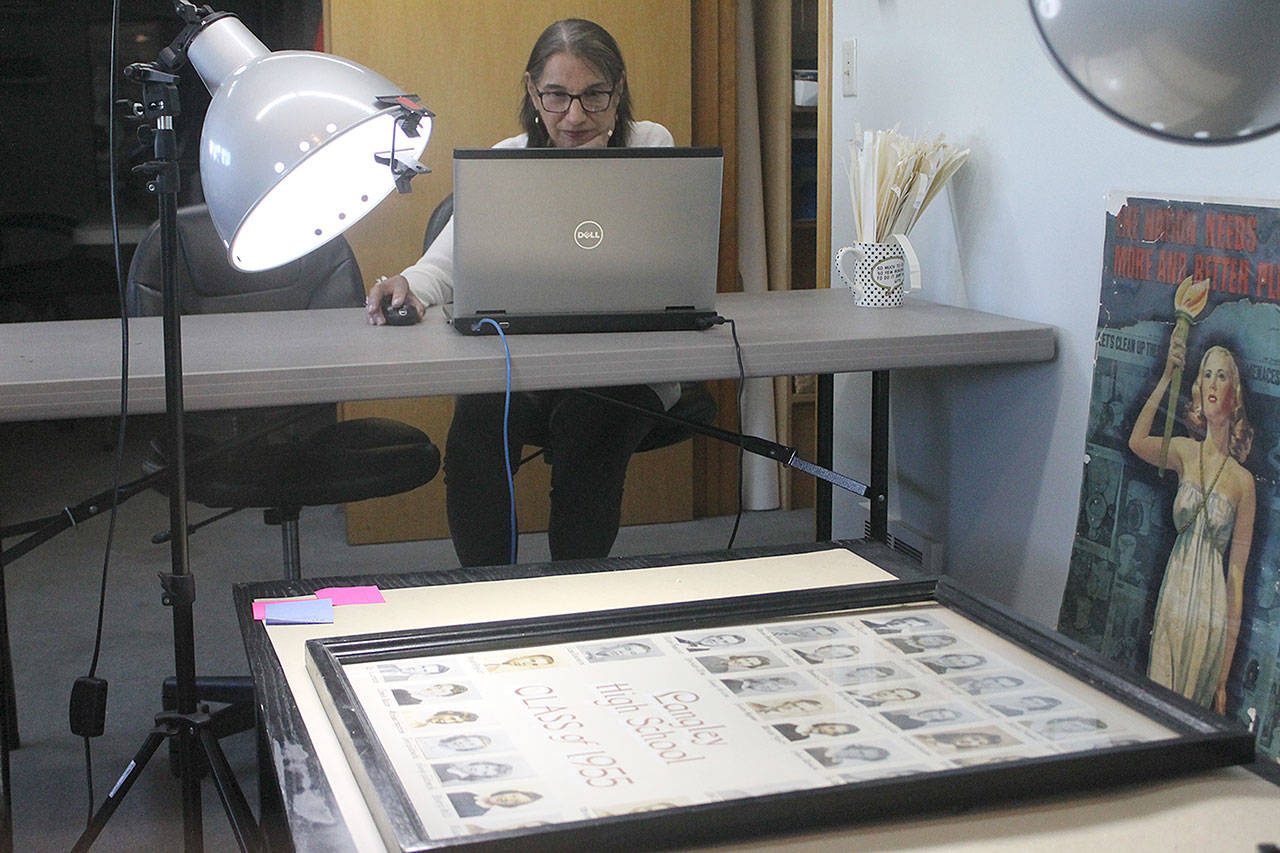 Evan Thompson / The Record — Jayne Keating, a volunteer and board member with the Island County Historical Society, works on digitizing old class photos of Langley High School students.