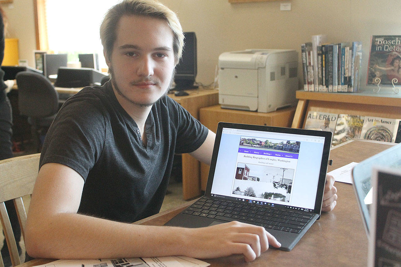 Evan Thompson / The Record — Avrey Scharwat displays the Historic Langley website on his laptop computer. Scharwat designed the website as part of an Eagle Scout project.