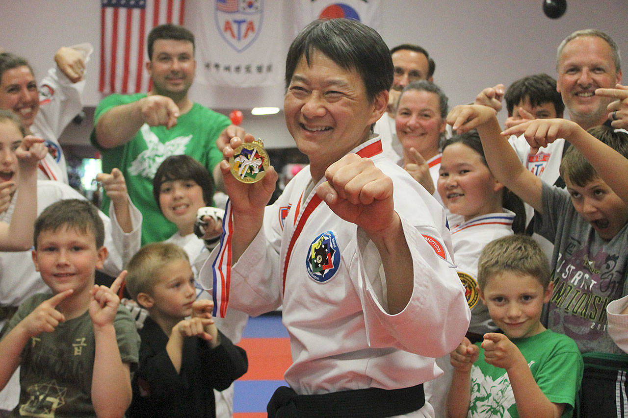 Evan Thompson / The Record &mdash; Jeffrey Chia won the sparring title at the American Taekwondo Association World Championships on June 25 in Little Rock, Ark. Students and instructors at Armstrong&rsquo;s Taekwondo congratulated him at the mixed martial arts school on Monday afternoon.