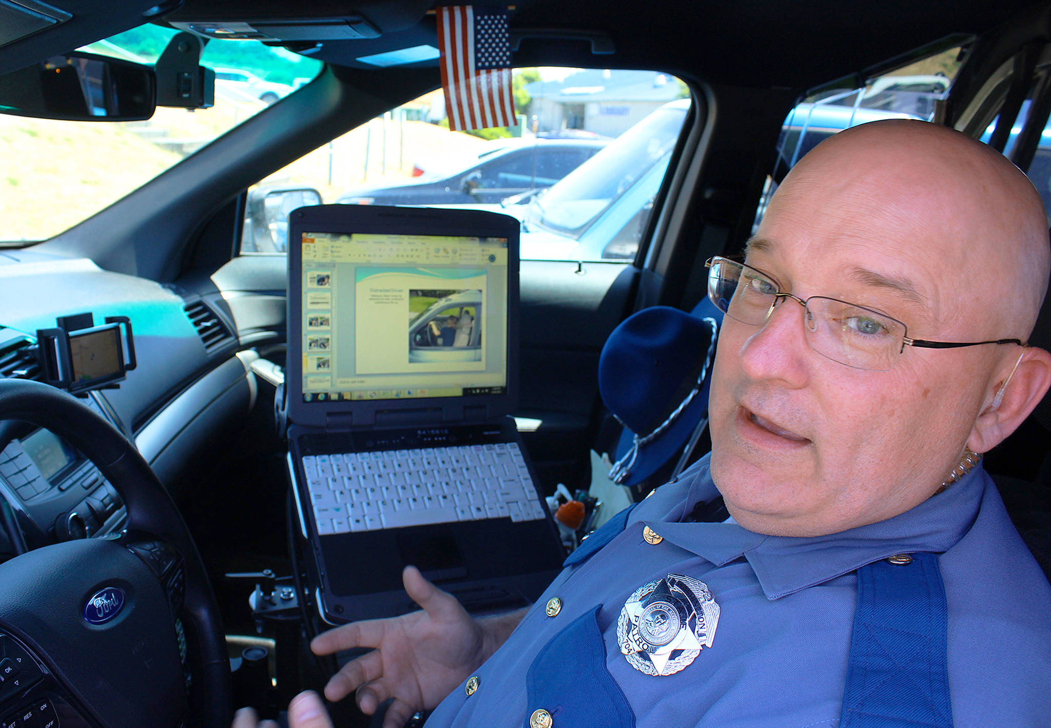 Beginning Sunday it&rsquo;s illegal under a new state law to have a cell phone or any electronic device in your hand while driving. State trooper Dave Martin advises: &ldquo;Just focus on getting from point A to point B.&rdquo;                                Photo by Patricia Guthrie/Whidbey News-Times