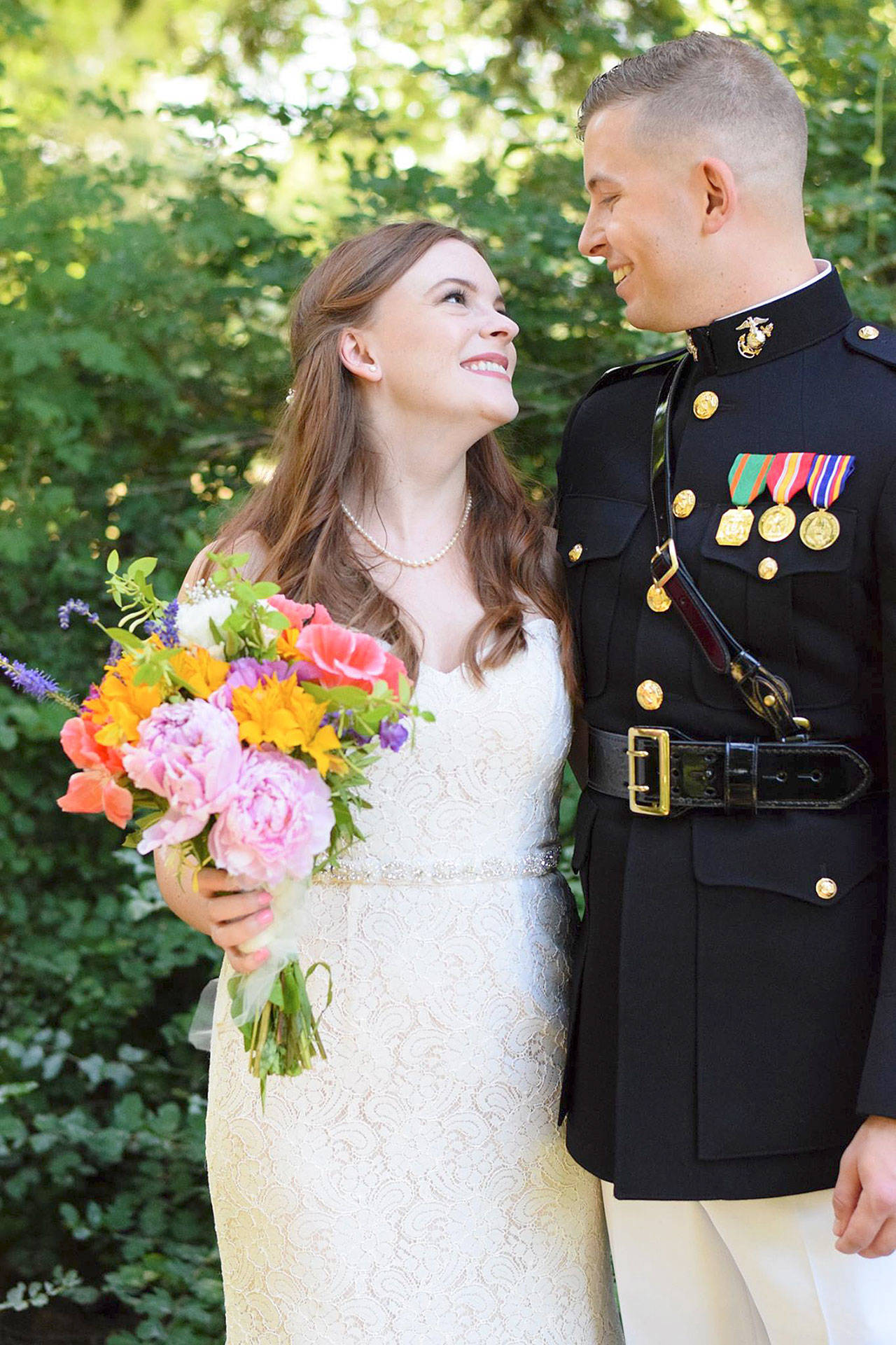 Contributed photo — Chandler Thompson, wearing his Marine Corps dress blue uniform, walks down the aisle after marrying Michelle Doyle on June 30 in Ferndale.