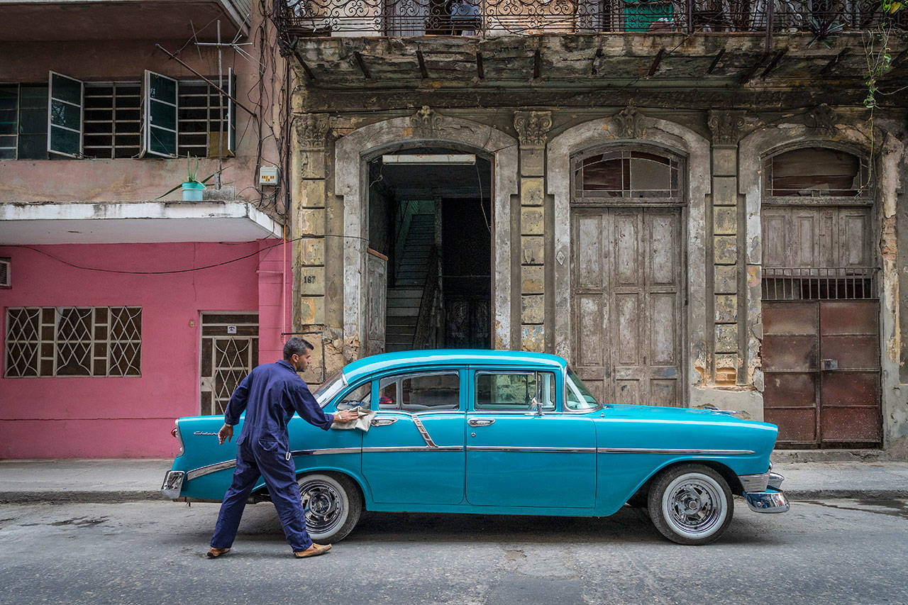 Marie Plakos photo — Marie Plakos captured a man rigorously cleaning his 1950’s Chevy. Maintaining retro American cars is an iconic sight in Cuba.