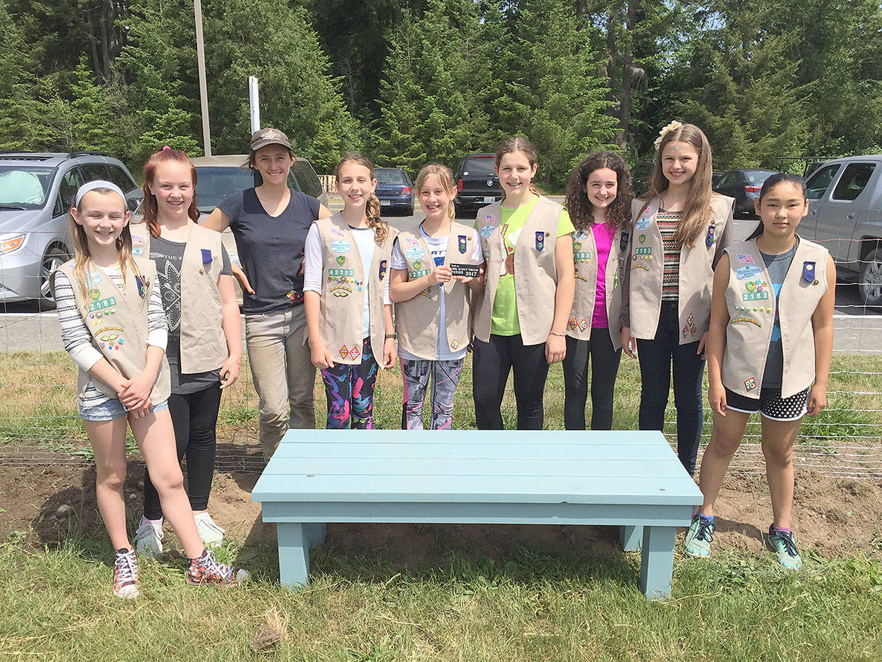 Evan Thompson / The Record — Cadette Girl Scout Troop 42183 donated a bench they made to South Whidbey High School’s garden. From left to right: Freja Heggenes, Phoebe Hawkins, garden coordinator Raelani Kessler, Abigail Ireland, Parker Forsyth, Emma Callahan, Eva Wirth, Taryn Henny, and Chloe Goethel.