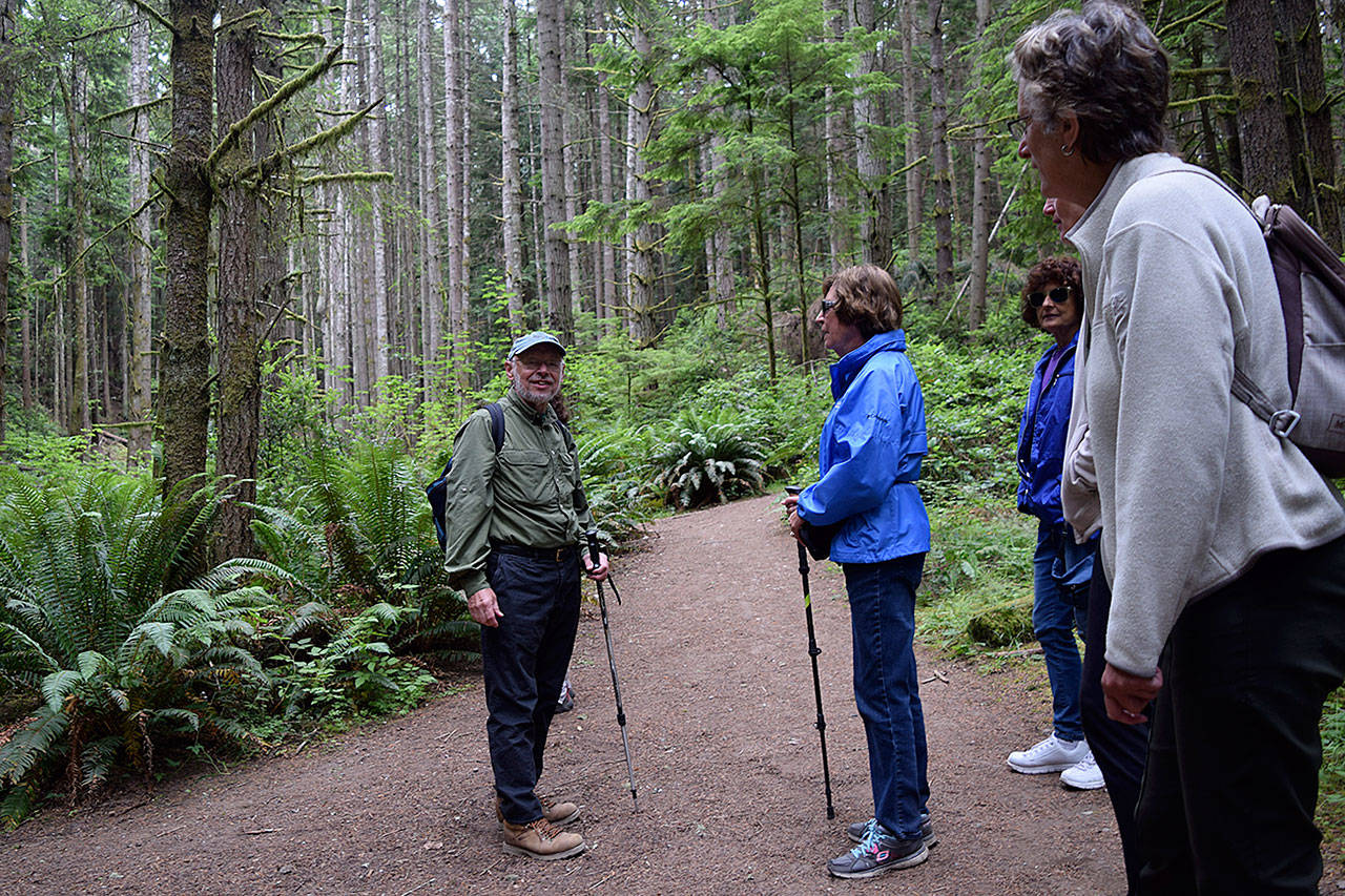 Kyle Jensen / The Record — Langley resident Richard Renninger, left, discusses possible routes in Saratoga Woods with the Meet Feet hiking group.