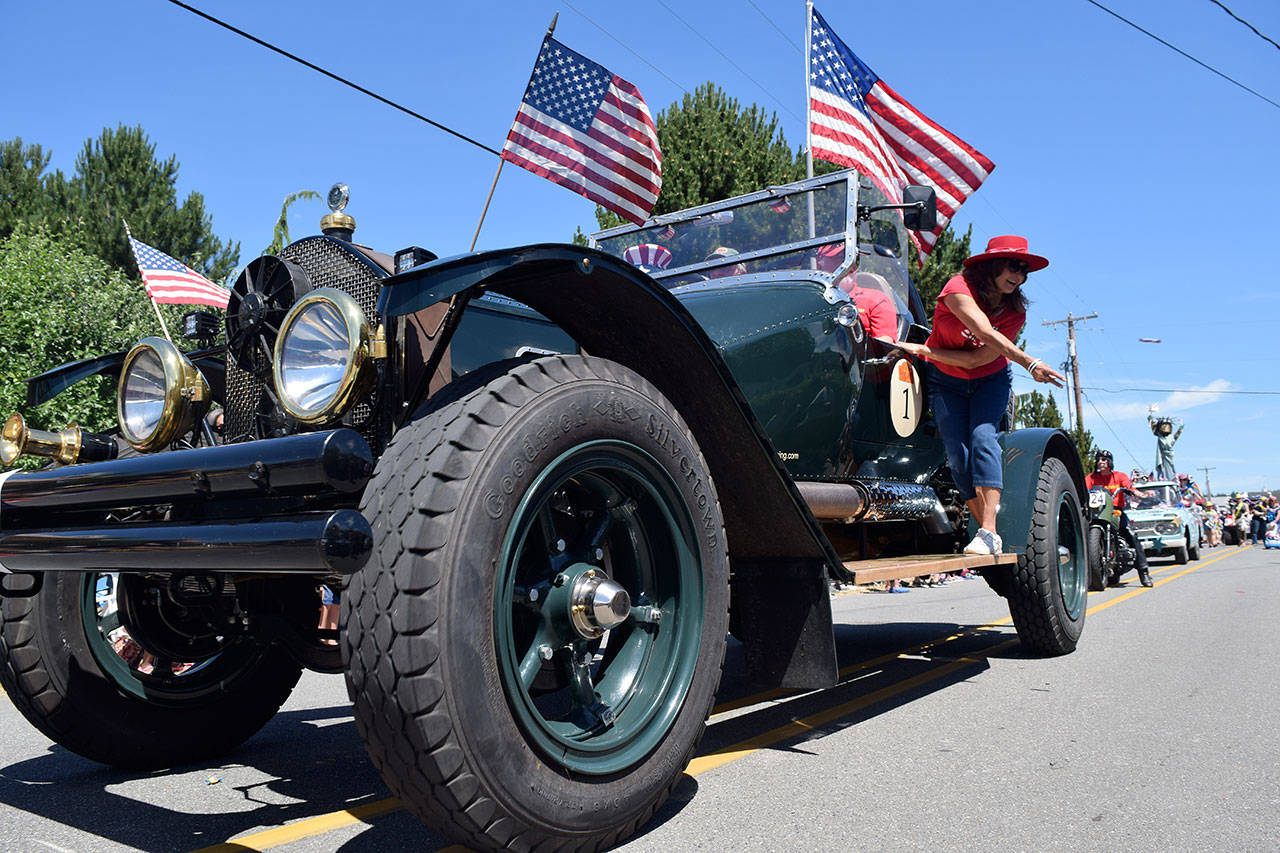 Kyle Jensen / The Record — Candy was thrown from most marchers during the Maxwelton Independence Day Parade, including this old fire engine.