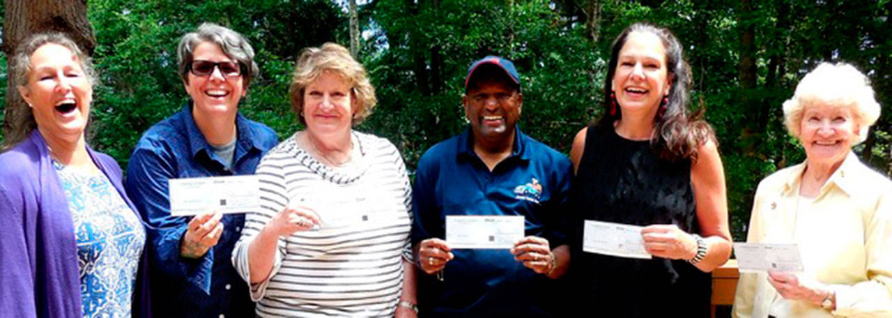 Contributed image — St. Augustine’s in-the-Woods Episcopal Church recently donated the proceeds of its annual Trash & Treasure Sale to five charity groups. Here they are holding up their checks. From left: Susan Sandri / 2017 Trash & Treasure chairwoman, Mel Watson for Time Together (a program within Island Co. Senior Services), Claire Creighton for Whidbey Animals’ Improvement Foundation, Art Taylor for the MobileTurkey Unit, Jane Bothel for Mother Mentors, and Jean Matheny for the Soup’s On! soup kitchen at Island Church in Langley.