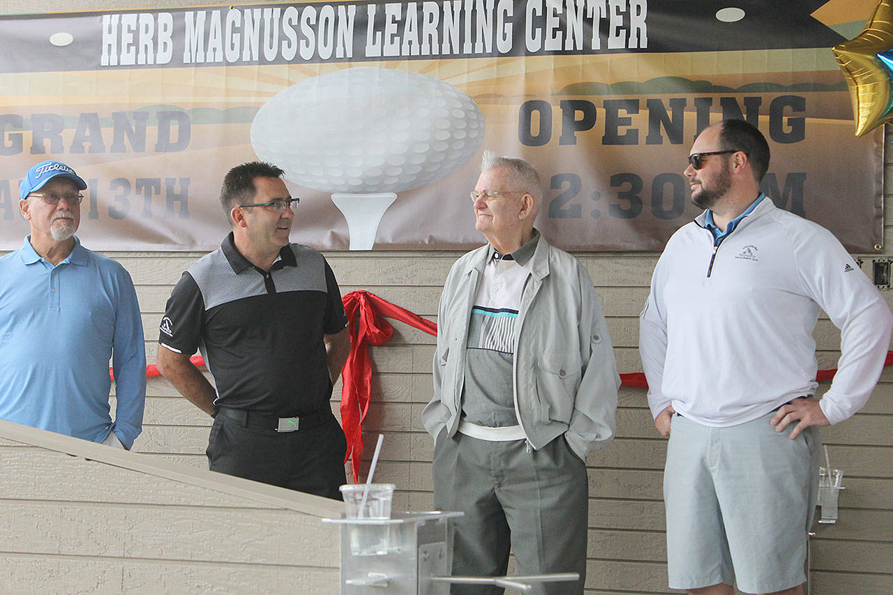 Evan Thompson / The Record — Brion Lubach, second from the left, speaks about Herb Magnusson (second from right) during the grand opening ceremony for the Herb Magnusson Learning Center.