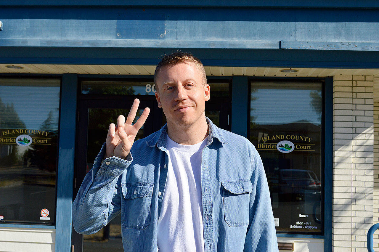 Jessie Stensland / Whidbey News Group &mdash; Macklemore dives the peace sign outside Island County District Court in Oak Harbor.
