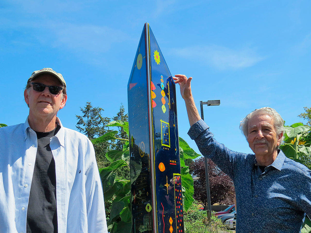 Burt Beusch photo — Artist Dale Reiger (left) and Langley Arts Commission Chairman Frank Rose stand next to Reiger’s new sculpture at a ceremony on Saturday at Clyde Alley.