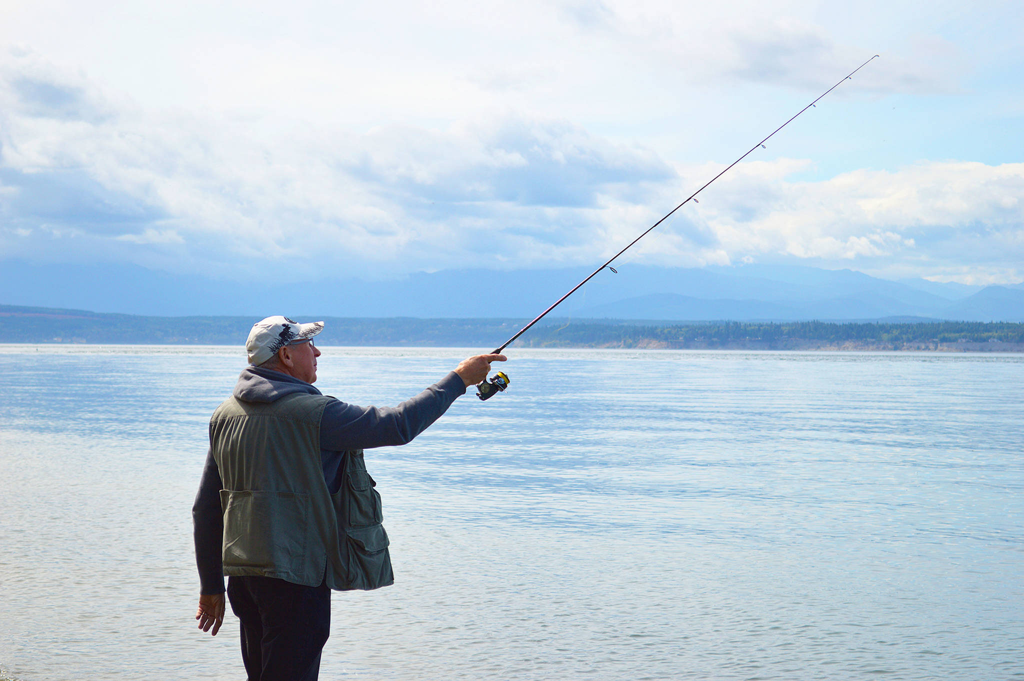 Laura Guido/Whidbey News Group — Lorne Balanko casts his line Thursday at Bush Point. Atlantic salmon from the recent net pen failure have been reportedly caught in the area, as well as other places around Whidbey.