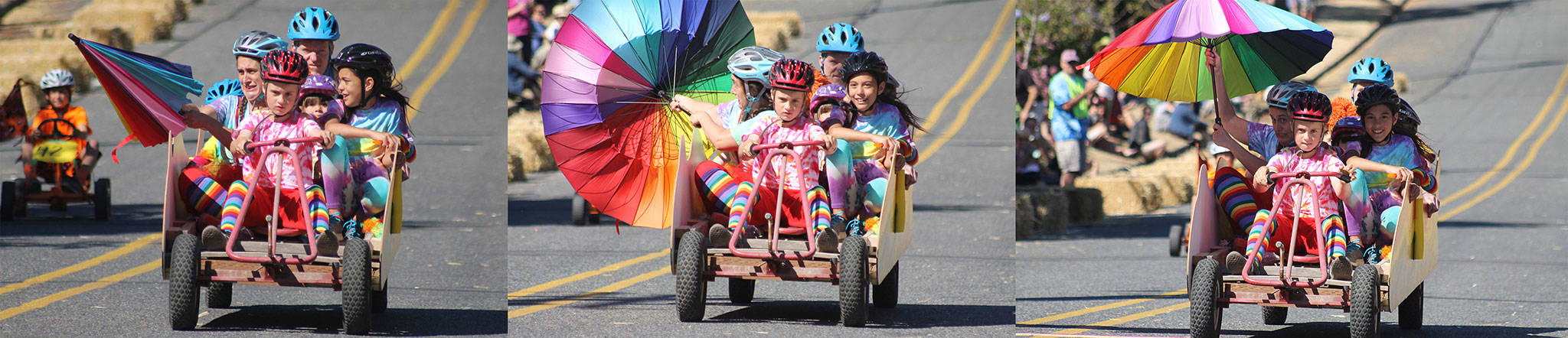 Evan Thompson / The Record — An unidentified group of racers in the Soup Box Derby deploy an umbrella to slow down their trip down First Street in Langley.