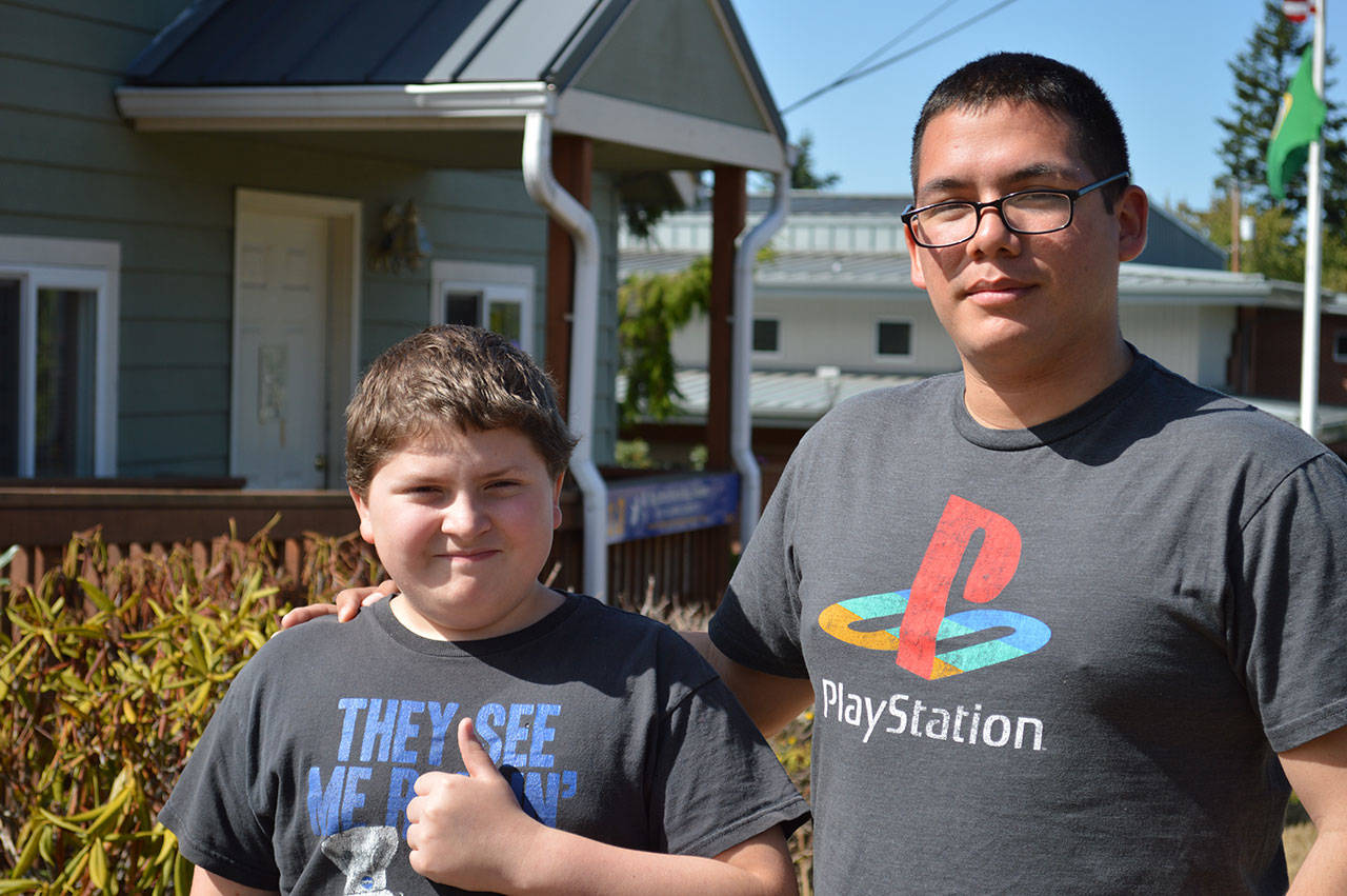Matthew Smith, left, stands with his “Big,” James Lopez. The two have been matched for eight months as part of Big Brother Big Sister Island County’s community-based mentoring program. Photo by Laura Guido/Whidbey News-Times