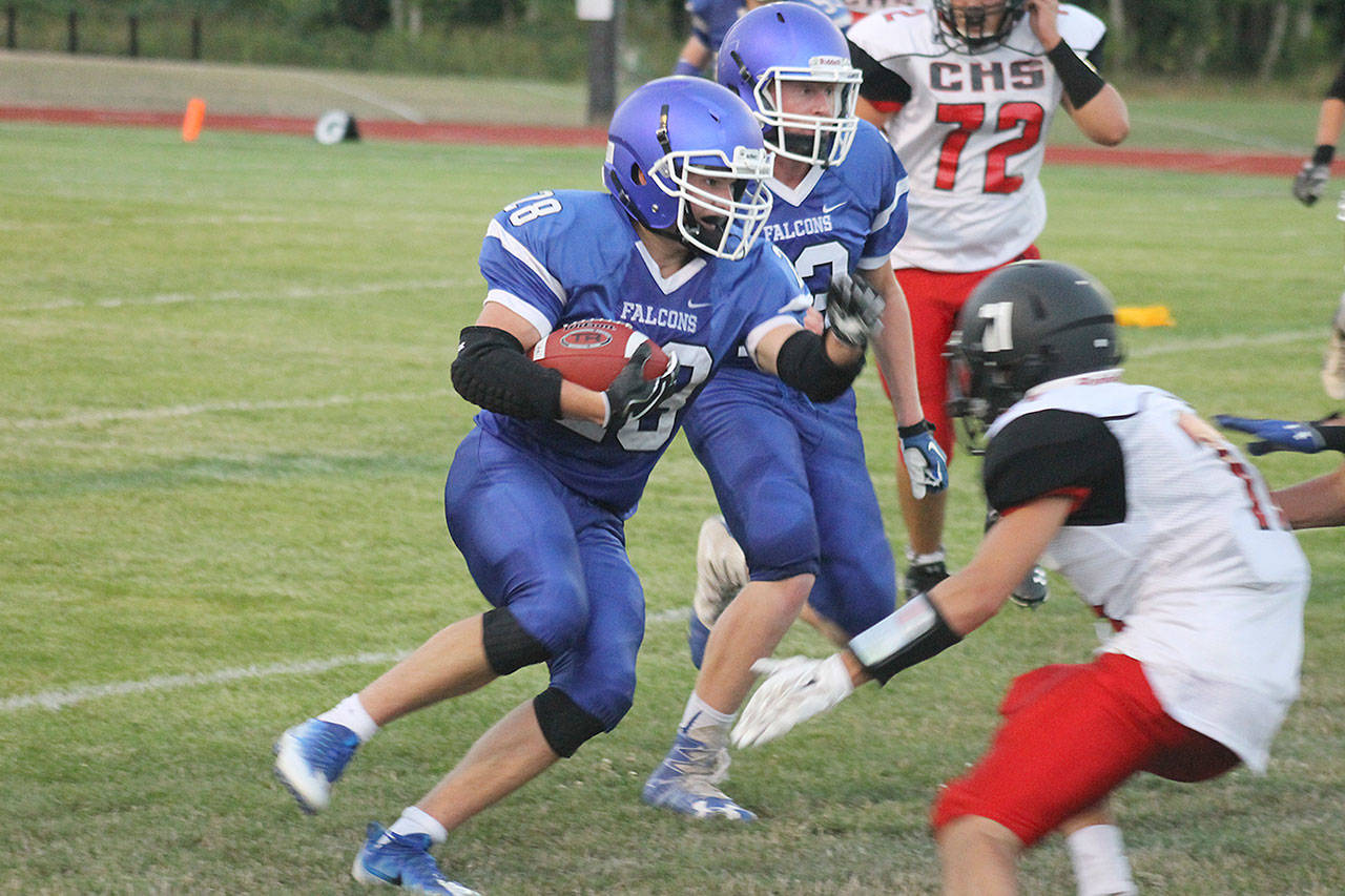 Evan Thompson / The Record &mdash; South Whidbey junior running back Caden Spear rushes for positive yardage during the Falcons&rsquo; season-opening game against Coupeville on Friday night at Jim Leierer Stadium at Waterman Field. The Falcons lost 18-0.