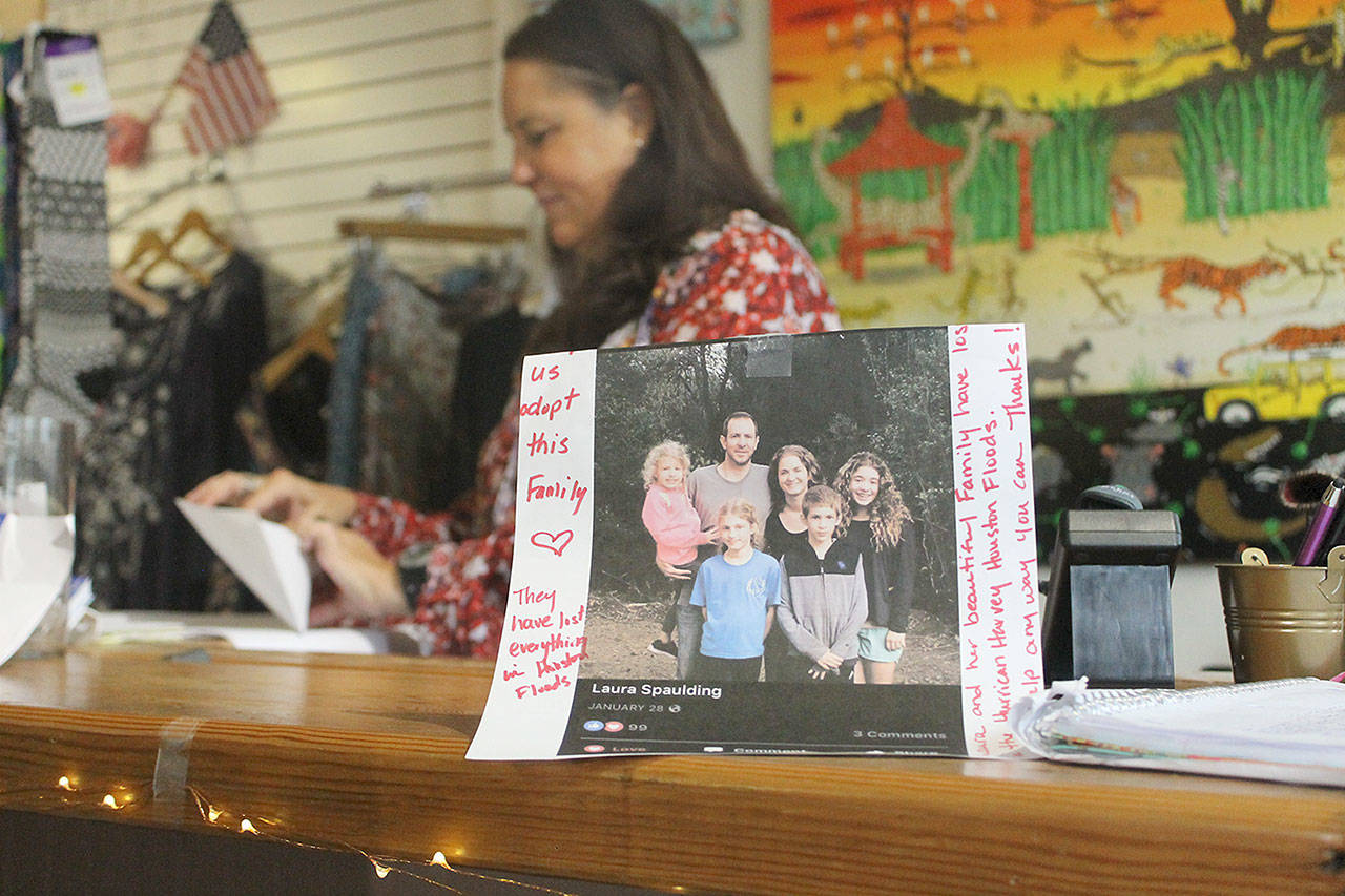 Evan Thompson / The Record — Lilly van Gerbig, co-owner of Fair Trade Outfitters on Anthes Avenue in Langley, seals an envelope with checks from South Whidbey residents intended for the Spaulding family. The family lost its home due to flooding from Hurricane Harvey.
