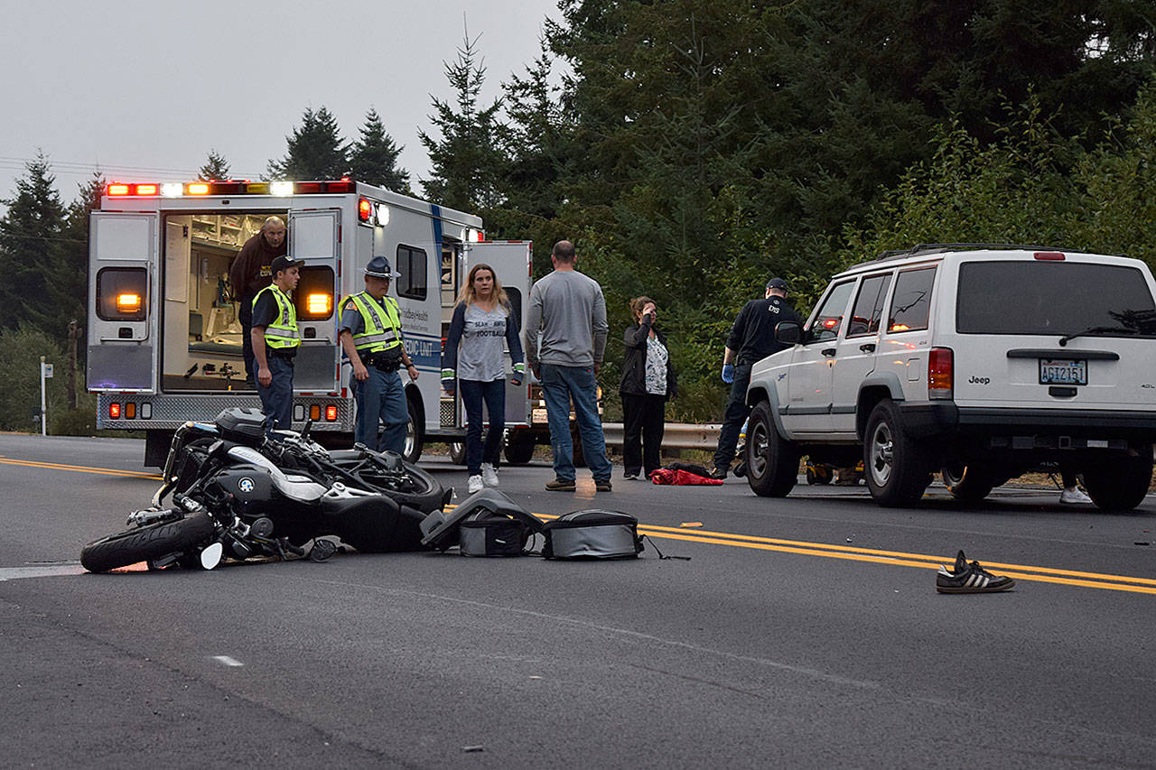 Kyle Jensen / The Record — Langley resident Adam Delong’s BMW motorcycle and shoes lie in the roadway after being hit by a white Jeep Cherokee, pictured.