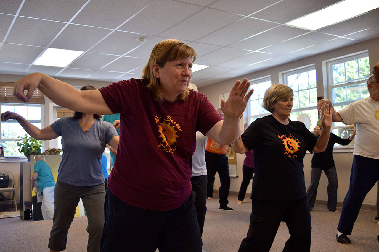 Kyle Jensen / The Record — Lynne Donnelly leads a class through tai chi movements. Donnelly is also the president of the Whidbey Island Holistic Health Association.