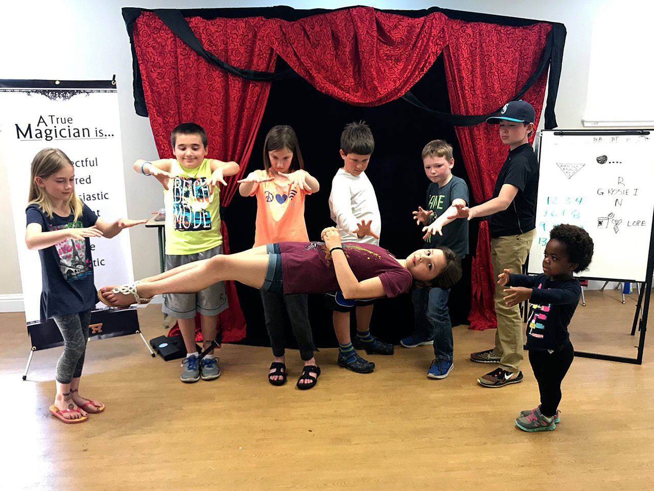 Contributed photo — Young magicians from JR Russell’s summer program work their magic to make someone levitate.