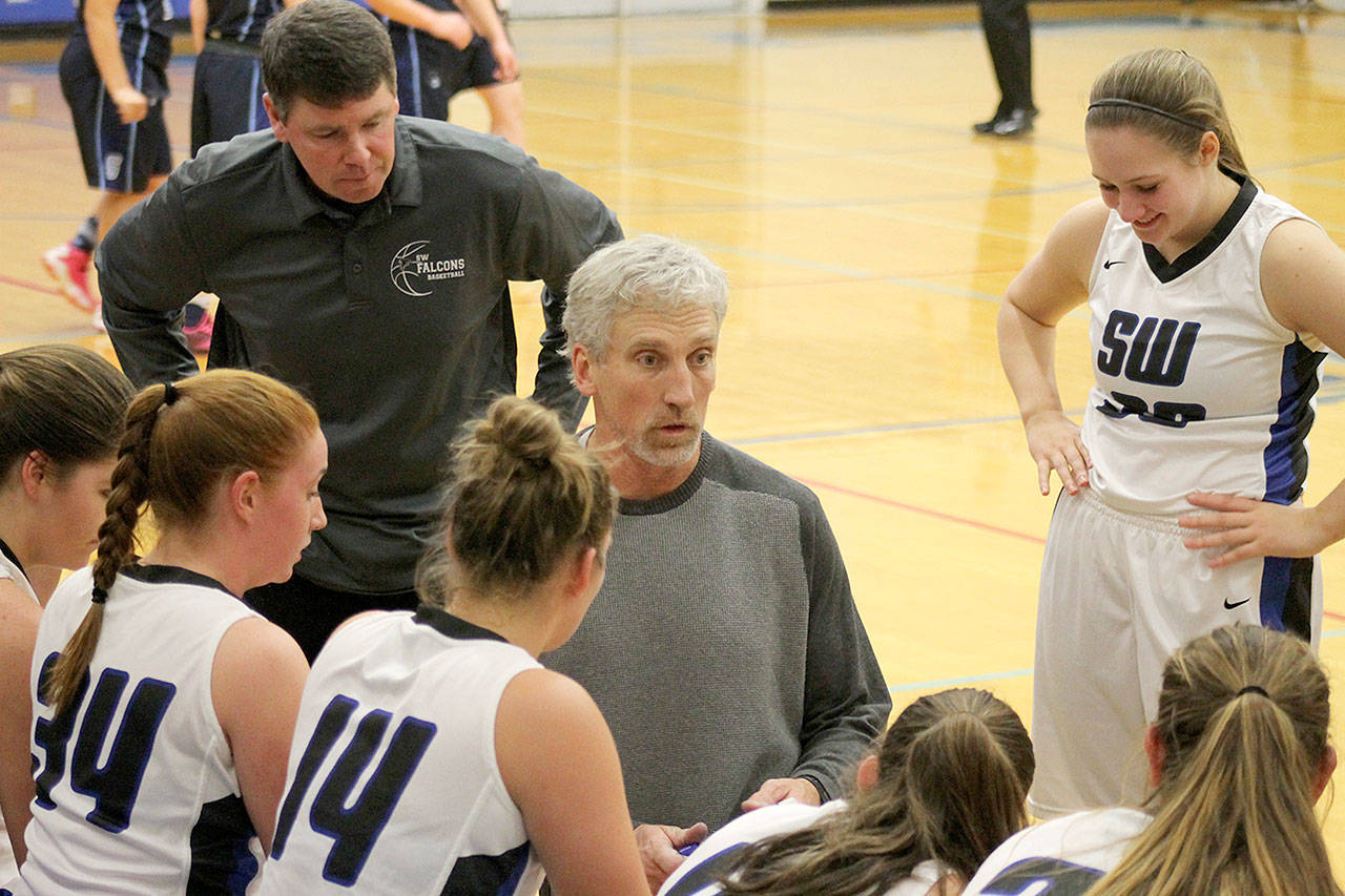 Record file — South Whidbey girls basketball coach Andy Davis (kneeling) resigned. Assistant coach Jeff Hanson (behind Davis) was hired to take over.