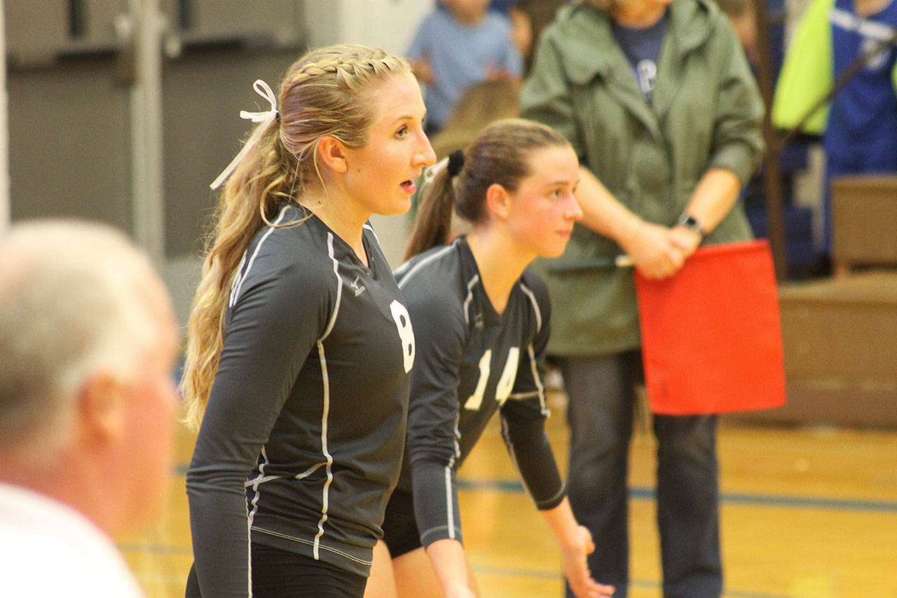Evan Thompson / The Record &mdash; South Whidbey seniors Kolby Heggenes (left) and Sophia Nielsen prepare for a serve by Archbishop Murphy on Thursday night at Erickson Gymnasium. The Falcons narrowly lost to the top-ranked Wildcats 3-2.