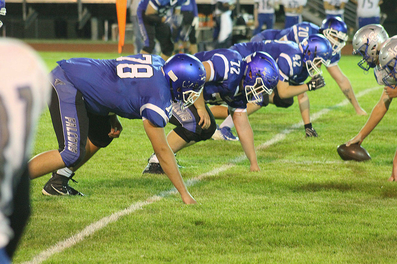 Evan Thompson / The Record — South Whidbey defensive linemen prepare for a snap by La Conner on Friday night at Jim Leierer Stadium at Waterman Field. The Falcons won 47-13.