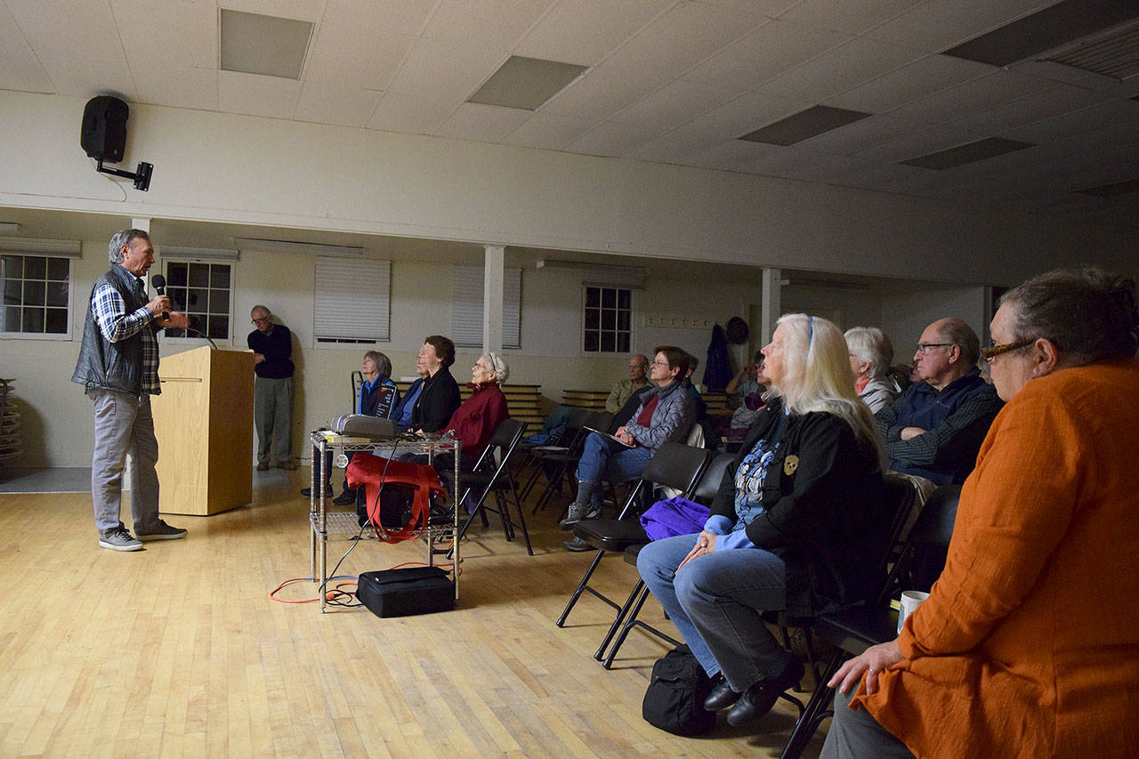 Kyle Jensen / The Record — Useless Bay resident Joe Quintana talks to Whidbey Audubon Society members about the negative effects of lighting up the night sky on Thursday night.