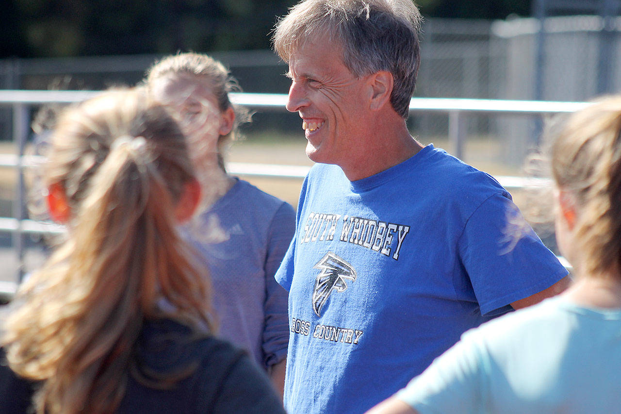 Evan Thompson / The Record — Doug Fulton goes over practice plans during the early part of the season in September. Fulton has coached South Whidbey cross country since 1997