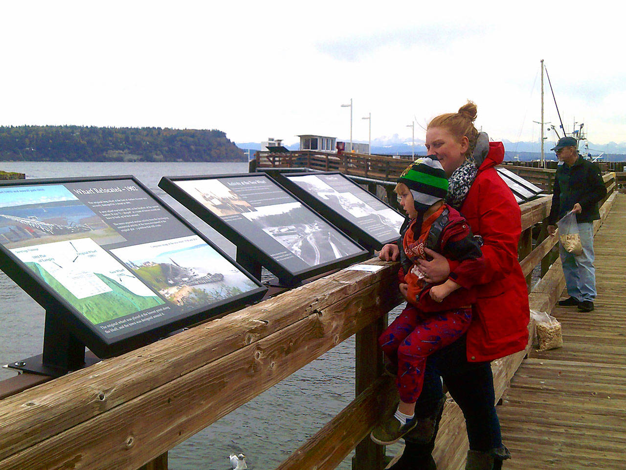 Lorinda Kay photo  Langley resident Sarah DeClercq and her son Benjamin look at the new displays with her Dad, Warner Johnson.