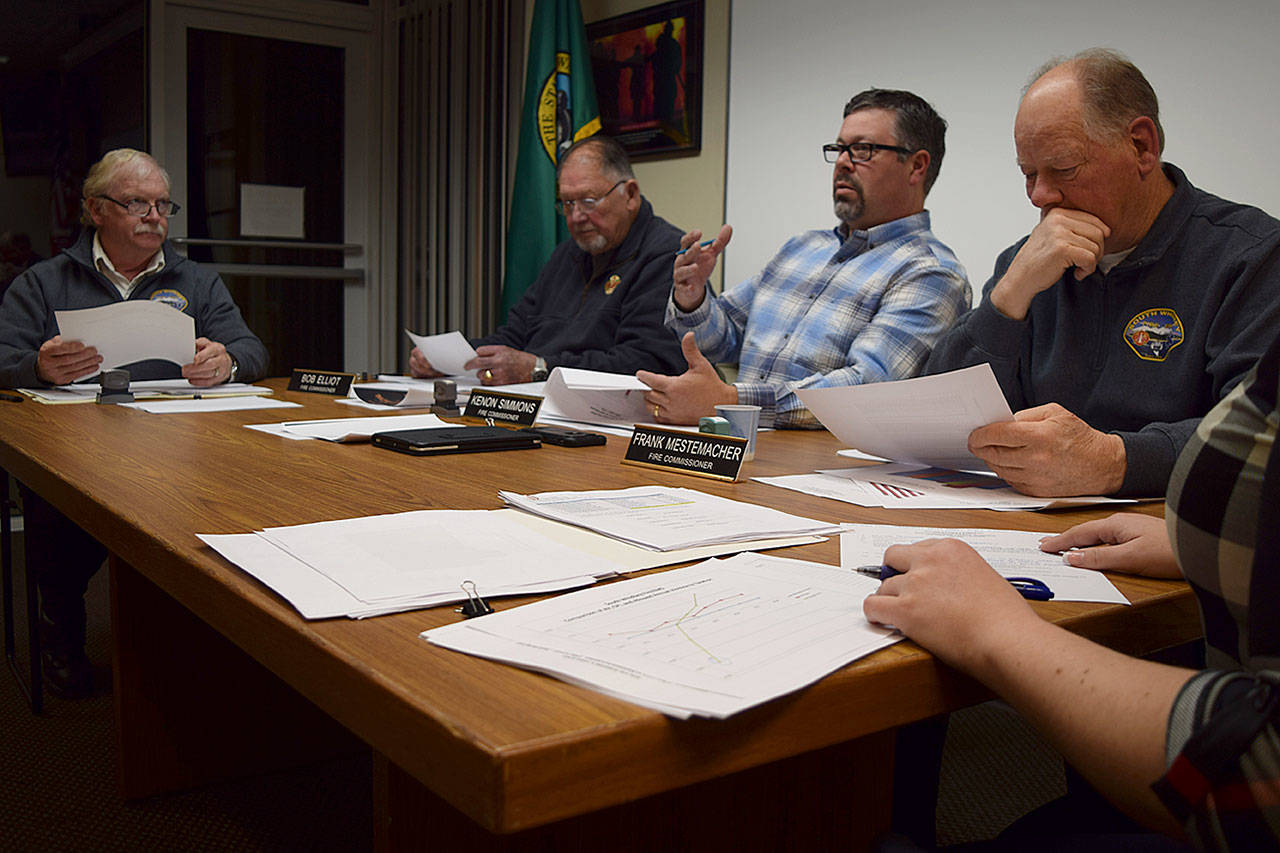 Kyle Jensen / The Record  South Whidbey Fire/EMS Chief Rusty Palmer (far left) goes over the 2018 budget with the commissioners.